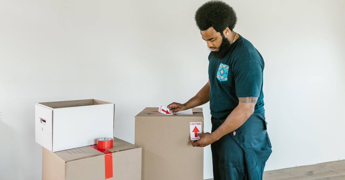 shipping cheese - Man in Blue Crew Neck T-shirt and Blue Denim Jeans Holding White Box shipping cheese - Man in Blue Crew Neck T-shirt and Blue Denim Jeans Holding White Box