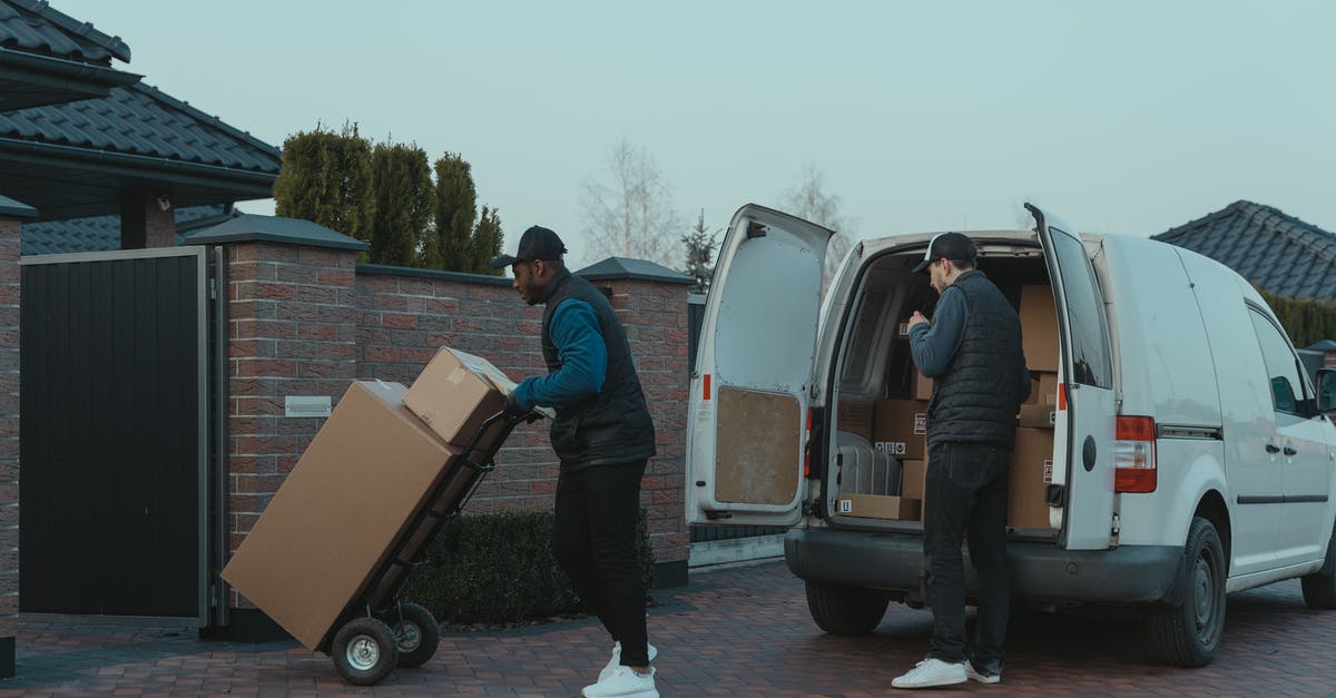 shipping cheese - Man in Blue Jacket Standing Beside White Van shipping cheese - Man in Blue Jacket Standing Beside White Van