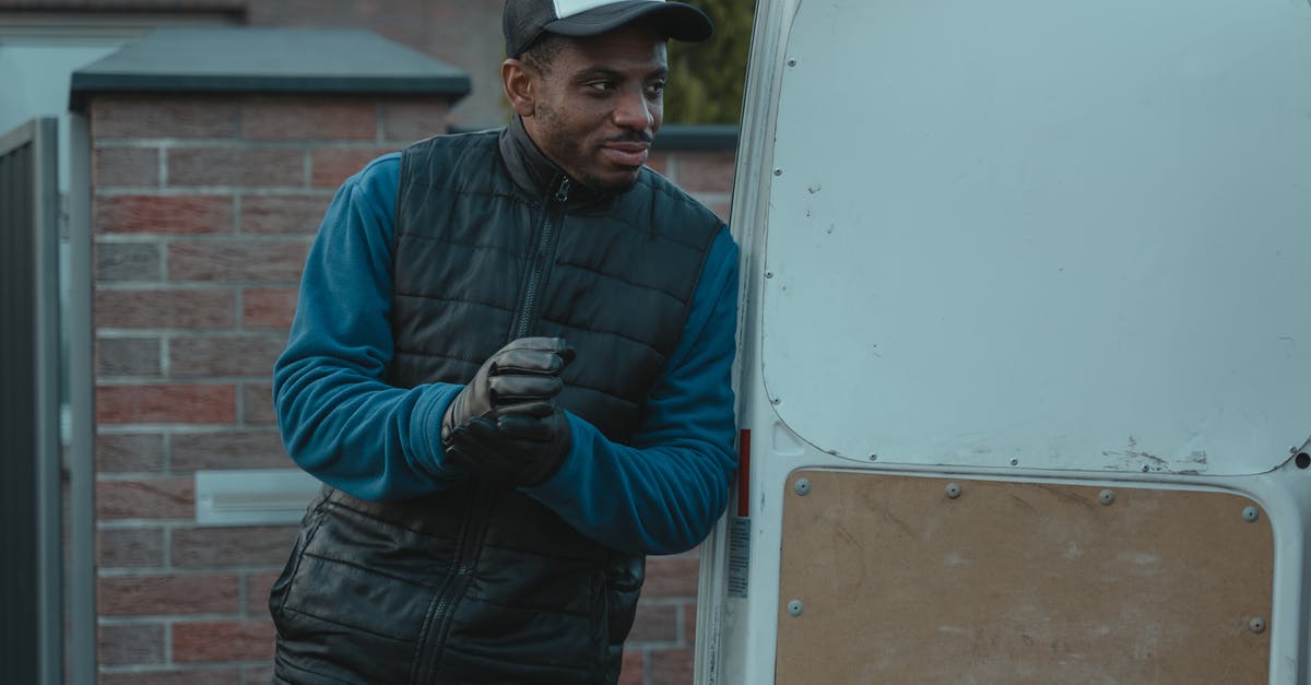 shipping cheese - Man in Blue Jacket and Black Pants Holding Black Smartphone shipping cheese - Man in Blue Jacket and Black Pants Holding Black Smartphone