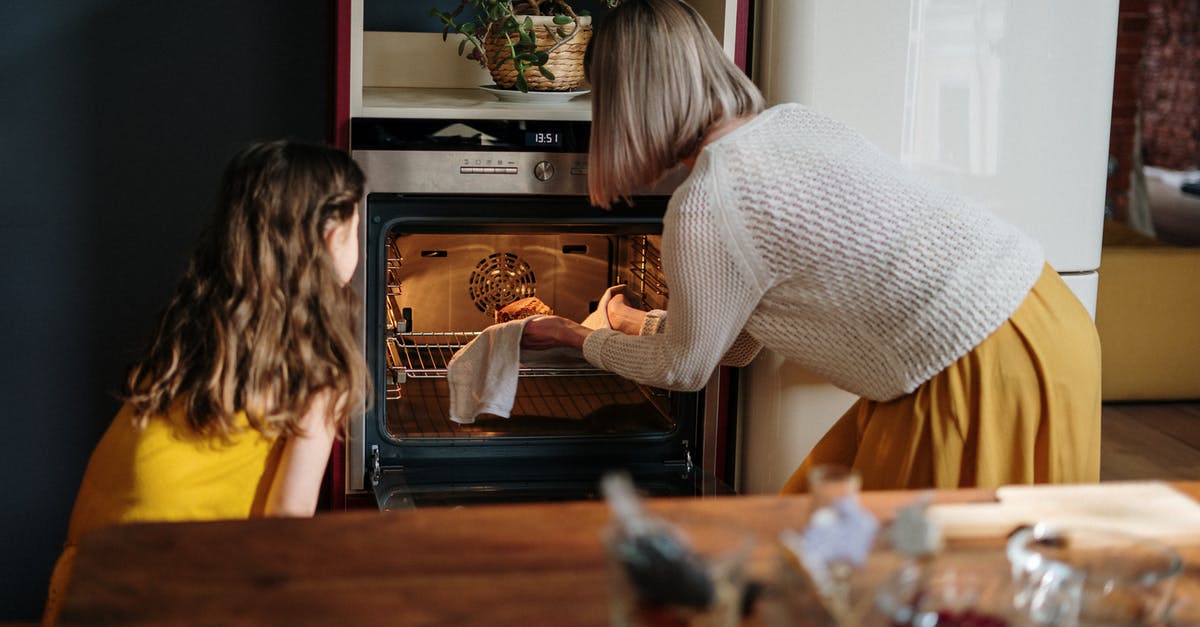 Should an oven be left to cool if cooking at a lower temperature? - Woman in White Sweater Baking Cake