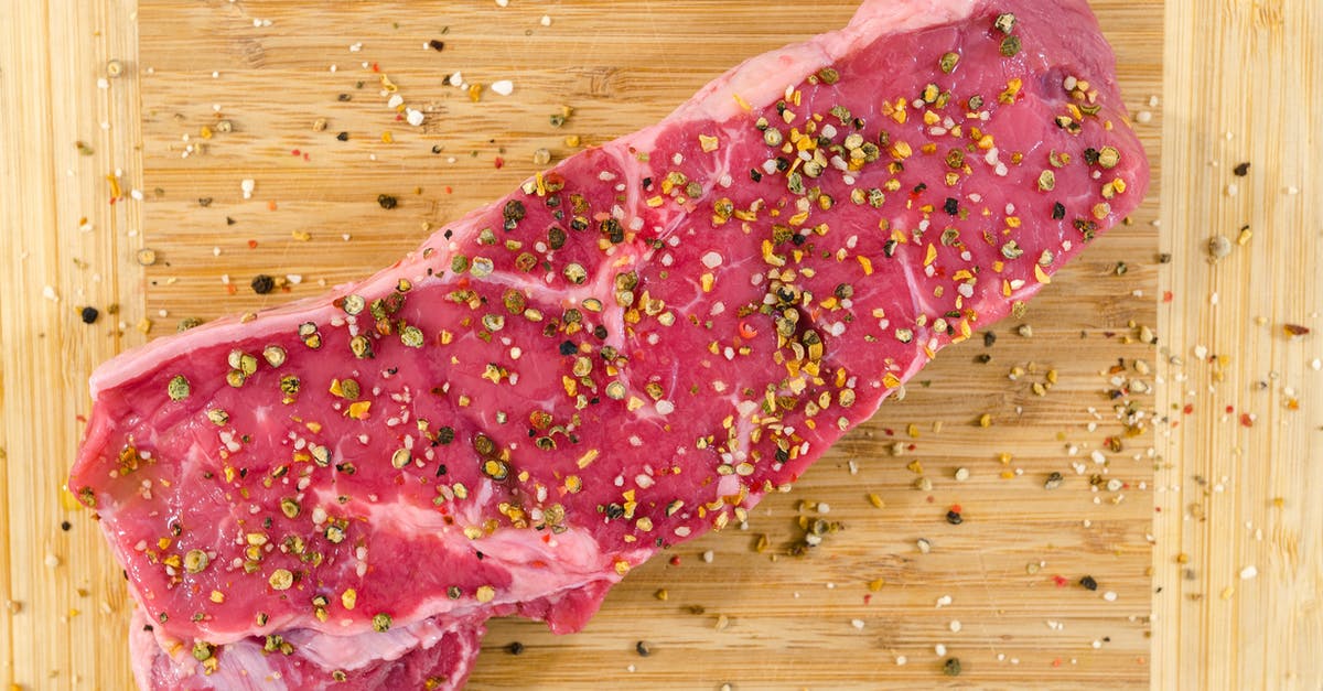 Should beef jerky be cut with or across the grain? - Raw Meat on Beige Wooden Surface Should beef jerky be cut with or across the grain? - Raw Meat on Beige Wooden Surface