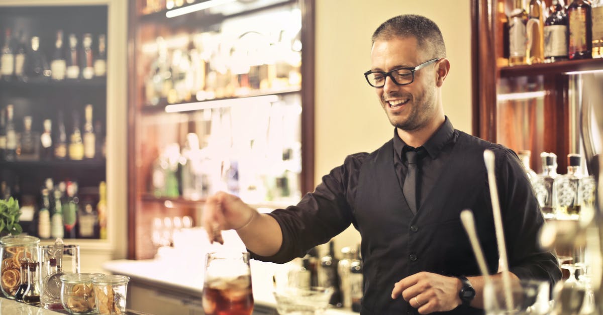 Should boiled legumes cool before processing? - Happy young male barkeeper standing at counter and preparing alcohol cocktail for order while working in modern pub Should boiled legumes cool before processing? - Happy young male barkeeper standing at counter and preparing alcohol cocktail for order while working in modern pub