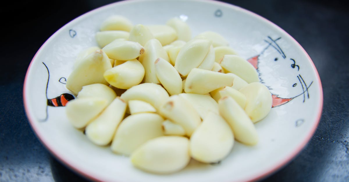 Should Chorizo Be Peeled Before Cooking? - Garlic in White Ceramic Plate