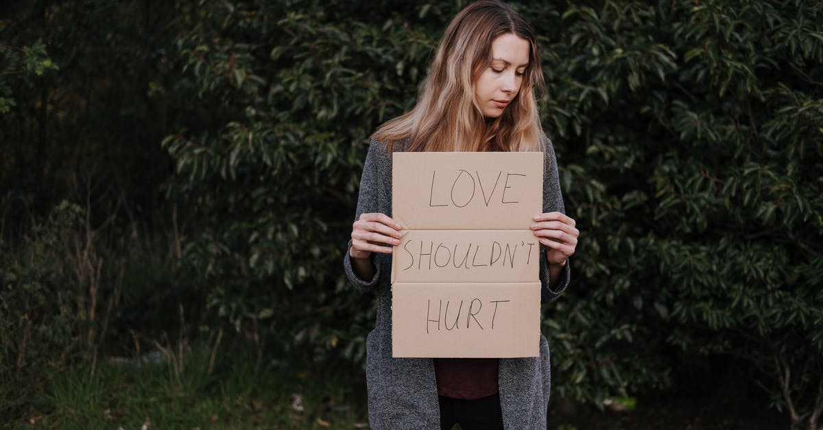 Should eggnog be chunky? - Lonely upset female in casual outfit standing near trees and grass while holding cardboard against abuse with inscription Love Should Not Hurt Should eggnog be chunky? - Lonely upset female in casual outfit standing near trees and grass while holding cardboard against abuse with inscription Love Should Not Hurt