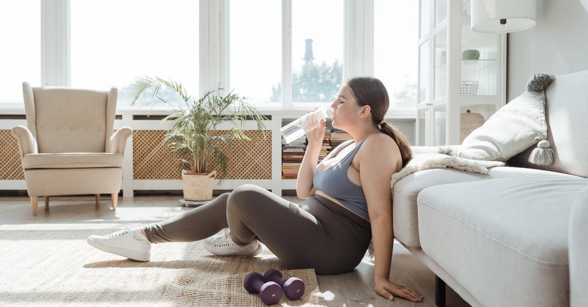 Should I be concerned about drinking tap water? - Woman in Blue Tank Top and Black Shorts Sitting on White Couch Should I be concerned about drinking tap water? - Woman in Blue Tank Top and Black Shorts Sitting on White Couch
