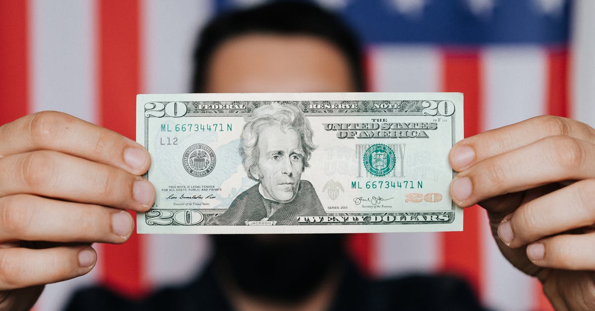 Should I buy more expensive oats? - Unrecognizable man showing 20 American dollars Should I buy more expensive oats? - Unrecognizable man showing 20 American dollars