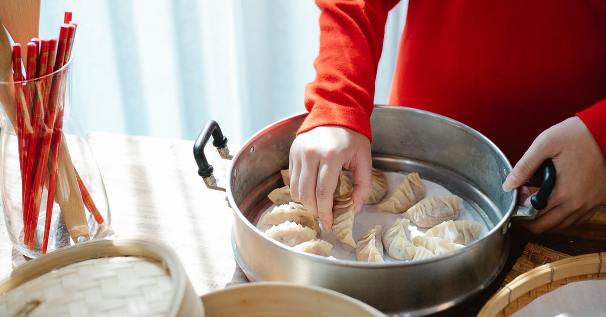 Should I freeze gyoza before or after cooking? - Person cooking gyoza dumplings in kitchen in daytime Should I freeze gyoza before or after cooking? - Person cooking gyoza dumplings in kitchen in daytime