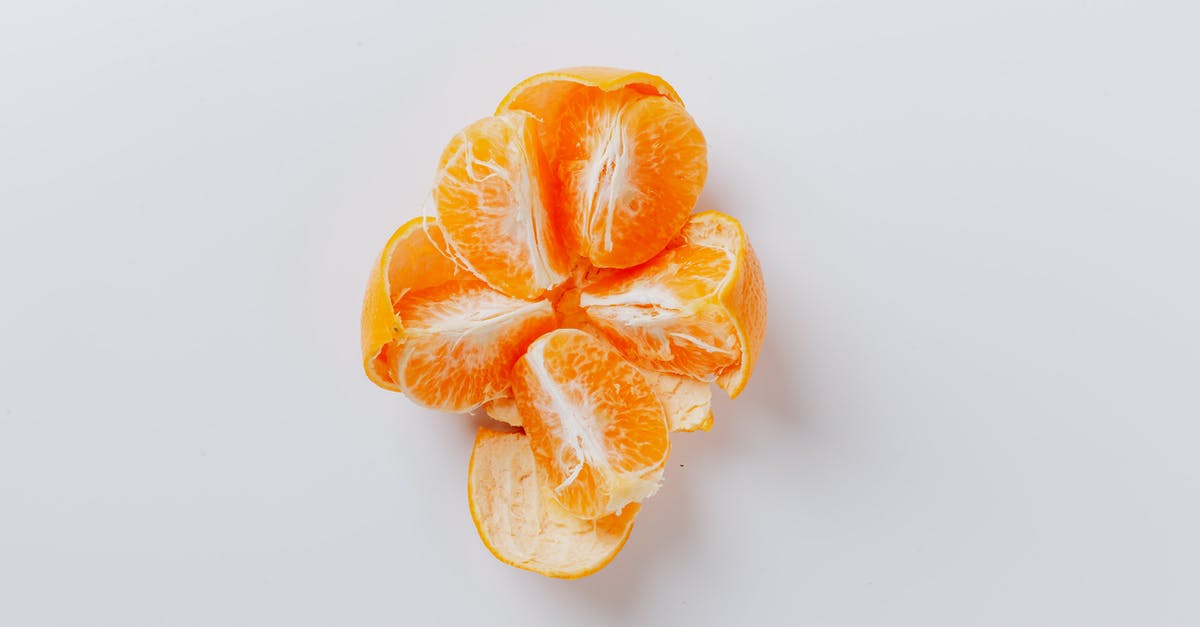Should I peel kiwifruit? - From above of fresh peeled juicy tangerine divided into five equal slices on gray background Should I peel kiwifruit? - From above of fresh peeled juicy tangerine divided into five equal slices on gray background
