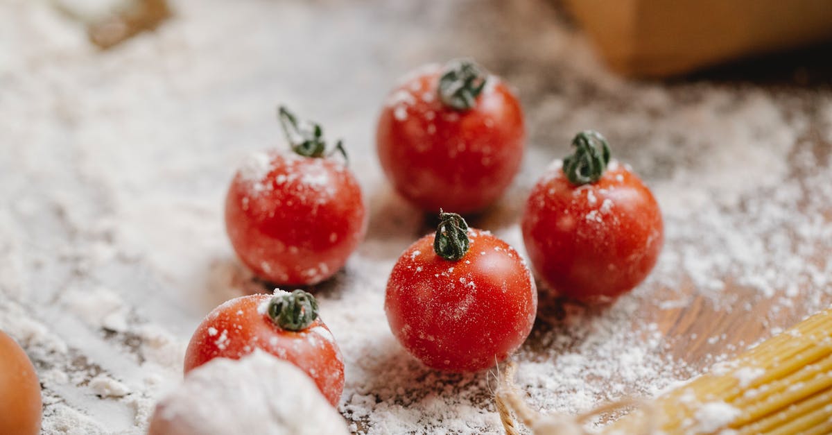 Should I use whole eggs or only yolks in Spaghetti alla Carbonara? - From above of ripe red cherry tomatoes with garlic and raw spaghetti on wooden table with flour Should I use whole eggs or only yolks in Spaghetti alla Carbonara? - From above of ripe red cherry tomatoes with garlic and raw spaghetti on wooden table with flour