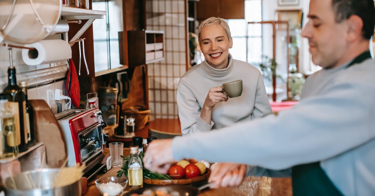 Should meat be seasoned before or after cooking? - Male seasoning delicious meatballs in pan against cheerful female beloved with cup of coffee in kitchen Should meat be seasoned before or after cooking? - Male seasoning delicious meatballs in pan against cheerful female beloved with cup of coffee in kitchen