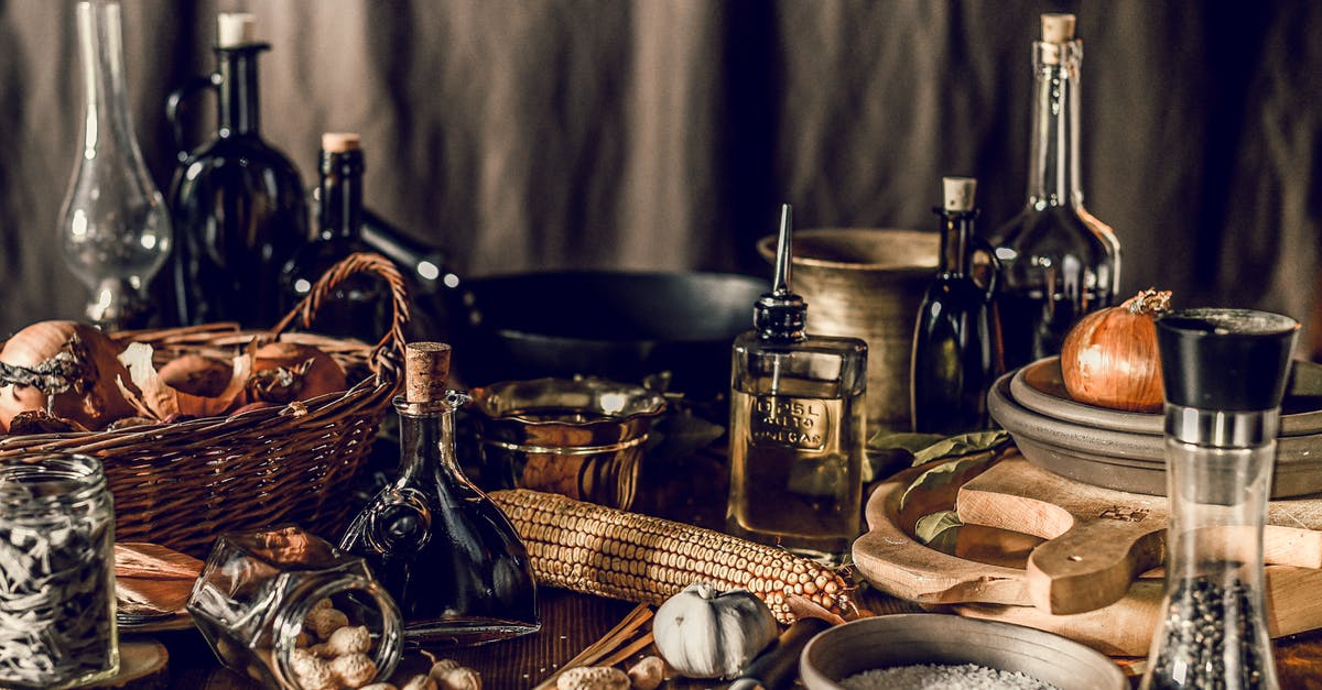 Should peanut oil be stored in the fridge? - Rustic still life with wooden and wicker utensils among ingredients and bottles of liquids on table Should peanut oil be stored in the fridge? - Rustic still life with wooden and wicker utensils among ingredients and bottles of liquids on table