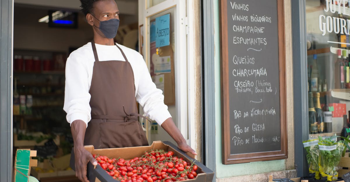 Should tomatoes be stored in the fridge? - A Man Holding a Crate with Tomatoes Should tomatoes be stored in the fridge? - A Man Holding a Crate with Tomatoes