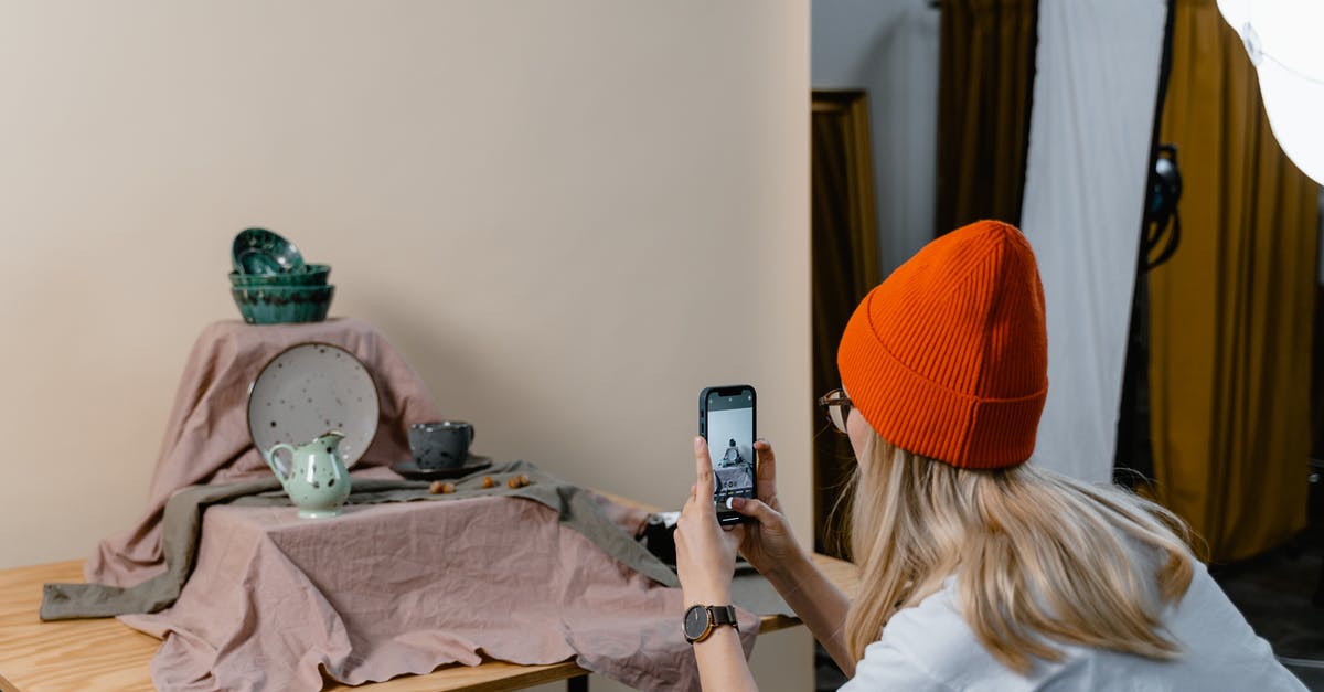 Should you store cutlery upside down? - Woman in White Shirt and Orange Knit Cap Holding a Smartphone Should you store cutlery upside down? - Woman in White Shirt and Orange Knit Cap Holding a Smartphone