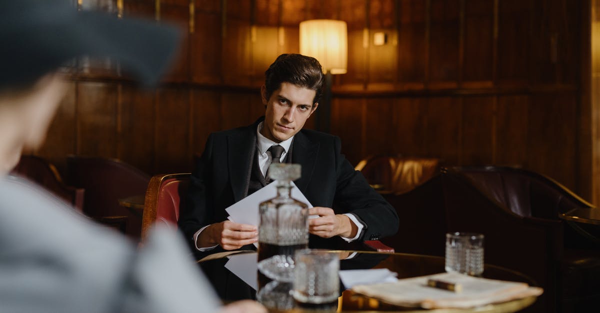 Silverfish in a restaurant - Man in Black Suit Jacket Sitting at the Table Silverfish in a restaurant - Man in Black Suit Jacket Sitting at the Table