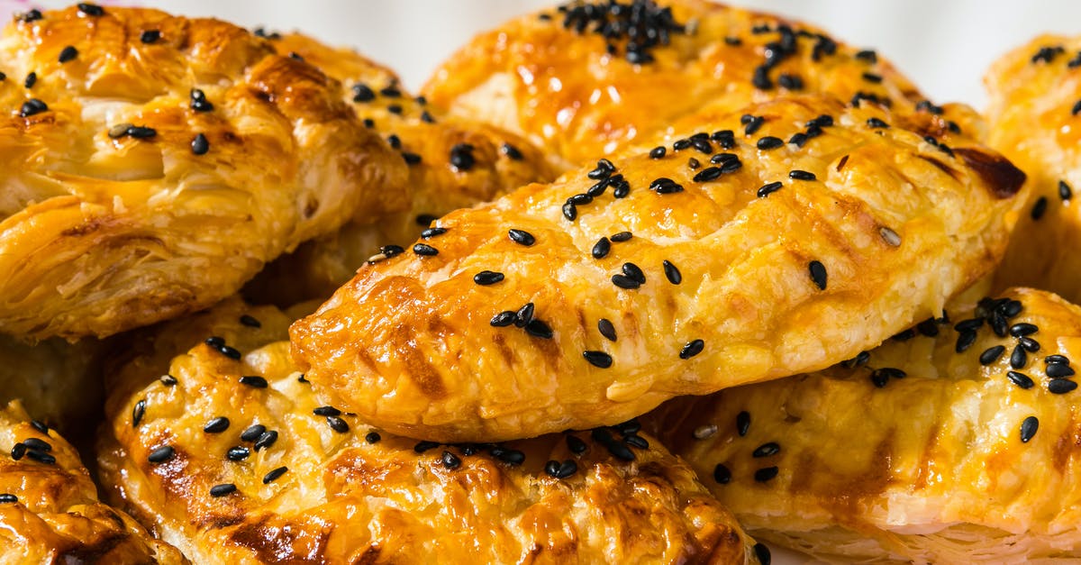 Simple Puff Pastry Dough - Fresh baked yummy pies on plate Simple Puff Pastry Dough - Fresh baked yummy pies on plate