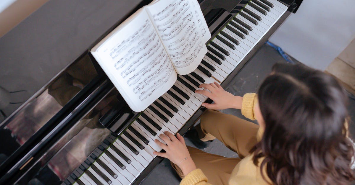 Skills that are only learned by professional chefs? - From above of crop faceless woman in warm yellow sweater with music book practicing music on piano in light classroom Skills that are only learned by professional chefs? - From above of crop faceless woman in warm yellow sweater with music book practicing music on piano in light classroom
