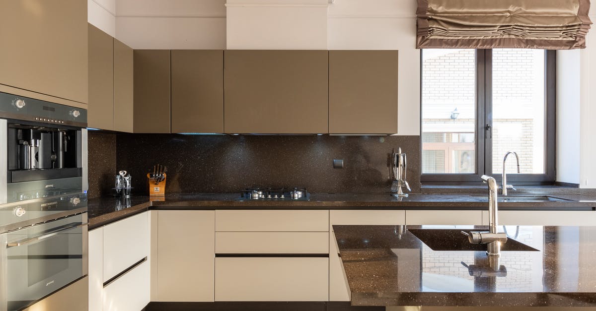 Slow oven brown rice - Table with tap placed in modern spacious kitchen with window and brown cupboards and contemporary appliances and various utensils at home Slow oven brown rice - Table with tap placed in modern spacious kitchen with window and brown cupboards and contemporary appliances and various utensils at home