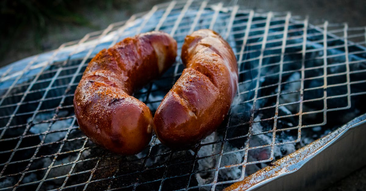 Smoking 3lb Pork Butt - Two Sausages on Charcoal Grill Smoking 3lb Pork Butt - Two Sausages on Charcoal Grill