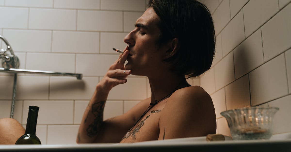 Smoking chicken breasts with and without skin - Man in Bathtub Smoking and Holding Bottle of Wine Smoking chicken breasts with and without skin - Man in Bathtub Smoking and Holding Bottle of Wine
