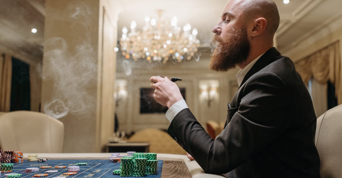 Smoking with chips after sous vide - Man in Black Suit Smoking Pipe While Playing on a Gaming Table Smoking with chips after sous vide - Man in Black Suit Smoking Pipe While Playing on a Gaming Table
