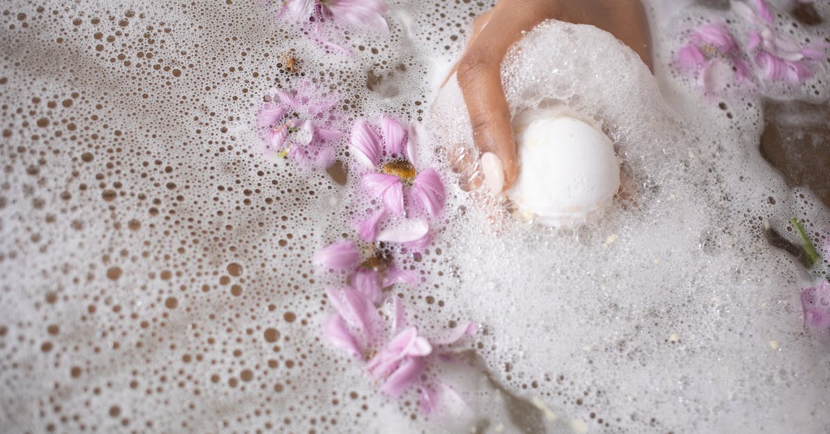 Soak store-bought mussels in fresh water without salt? - Woman holding ball of bath salt in water with foam and flowers Soak store-bought mussels in fresh water without salt? - Woman holding ball of bath salt in water with foam and flowers