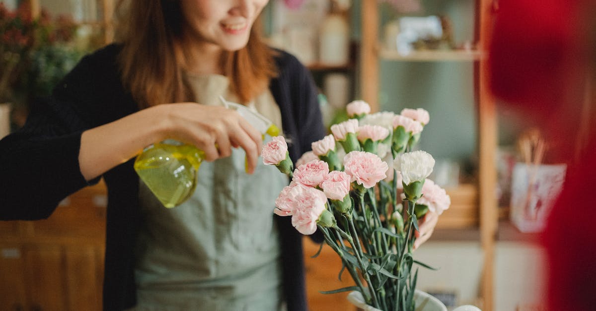 Soak store-bought mussels in fresh water without salt? - Asian woman spraying flowers in shop Soak store-bought mussels in fresh water without salt? - Asian woman spraying flowers in shop
