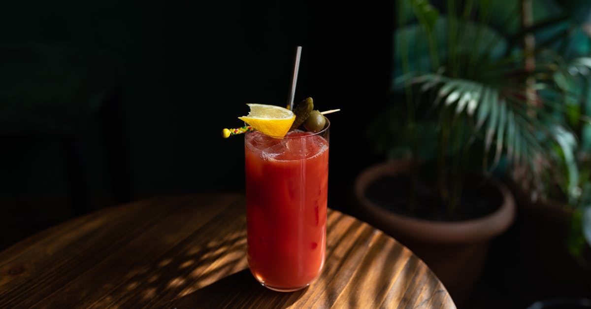 Soaking fruits and things in alcohol - A Drinking Glass with Red Liquid and Sliced Lemon on Top Soaking fruits and things in alcohol - A Drinking Glass with Red Liquid and Sliced Lemon on Top