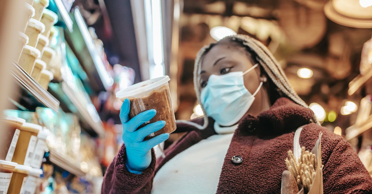 Soaking pulses overnight: safety vs refrigeration - Black woman in protective mask buying products Soaking pulses overnight: safety vs refrigeration - Black woman in protective mask buying products