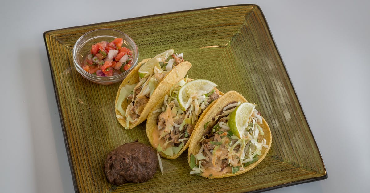 Softening meat with the vinegar / lemon / onion / pineapple etc. How does it work? [duplicate] - A Plate of Tacos with a Slice of Lemon and Salsa