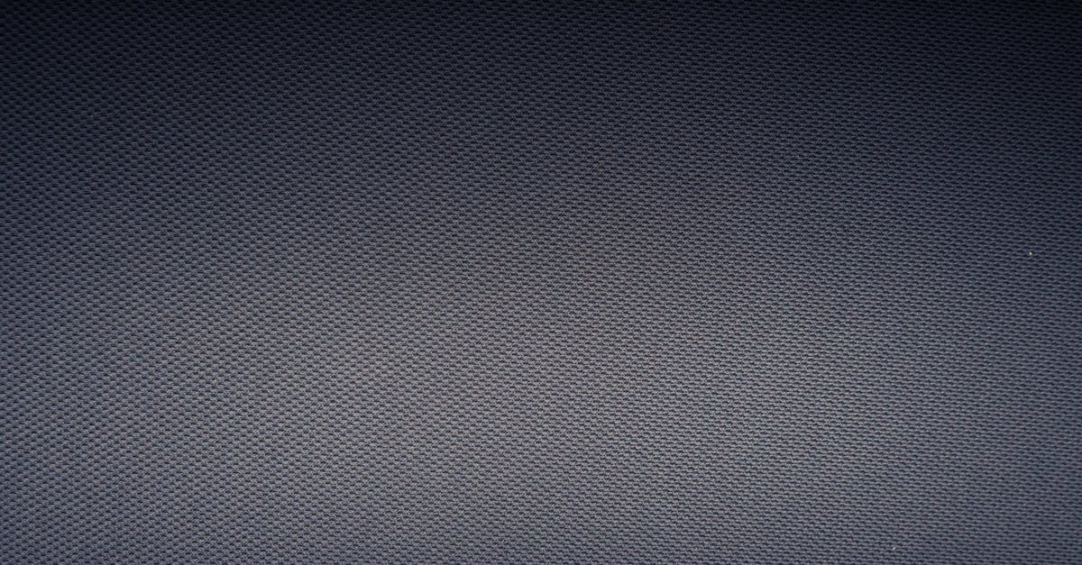 Something dark gray coming off of sheet pan after scouring - Textured background of carbon fiber fabric with tiny holes