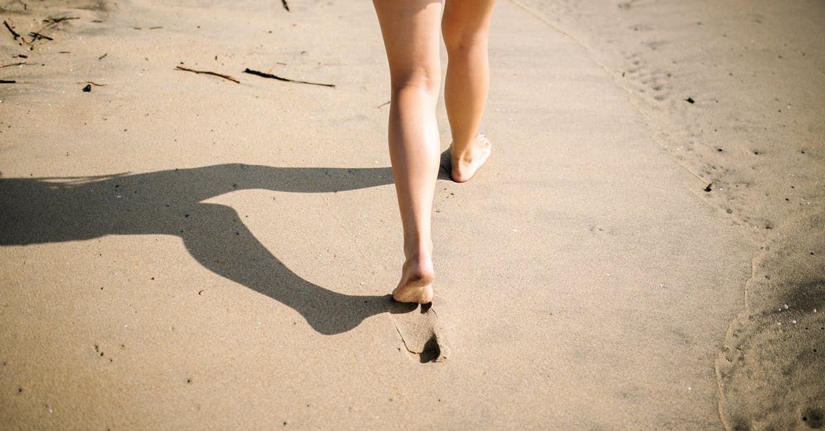 Soufflé the day before? - Woman in Blue Denim Shorts Walking on White Sand Soufflé the day before? - Woman in Blue Denim Shorts Walking on White Sand