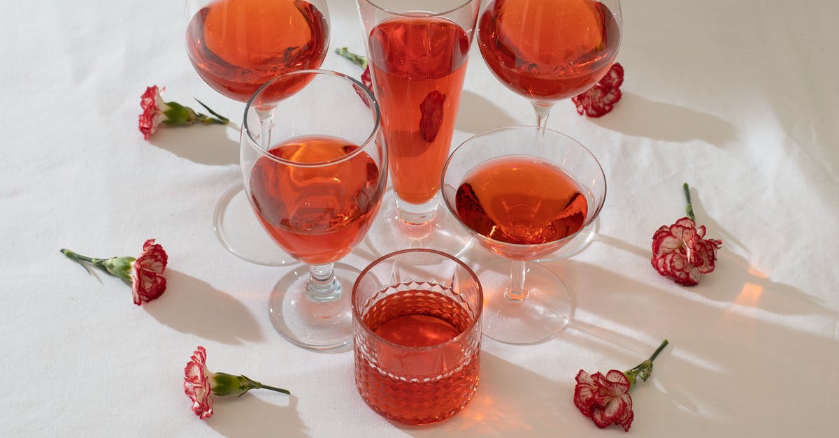 Soup has a floral taste - Arrangement of wineglasses with flowers on table Soup has a floral taste - Arrangement of wineglasses with flowers on table