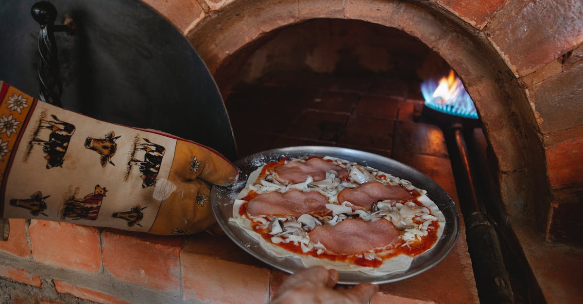 Sourdough pizza crust for wood-fired oven - Hand of a Person Placing Pizza on Aluminum Plate in Oven Sourdough pizza crust for wood-fired oven - Hand of a Person Placing Pizza on Aluminum Plate in Oven