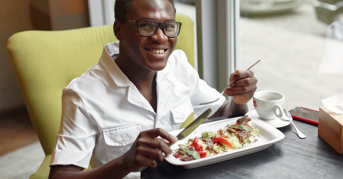 Sourdough Starter Black Spots - Cheerful man enjoying salad in cafe Sourdough Starter Black Spots - Cheerful man enjoying salad in cafe