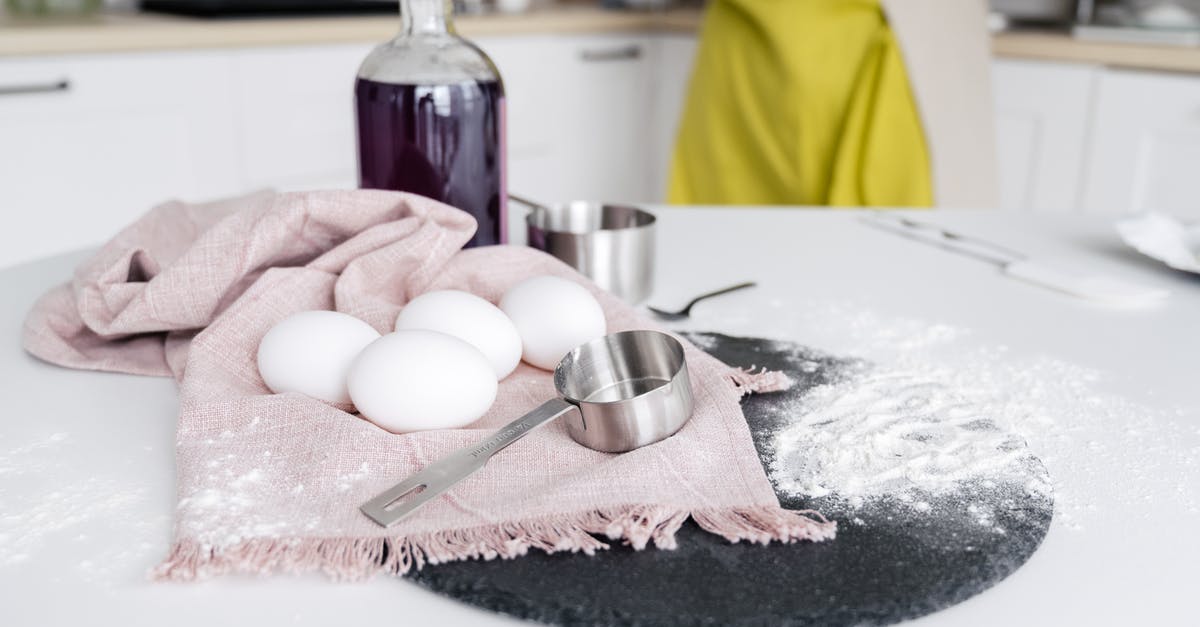 Sous vide egg white falling apart on cracking - Crop woman near table with eggs Sous vide egg white falling apart on cracking - Crop woman near table with eggs