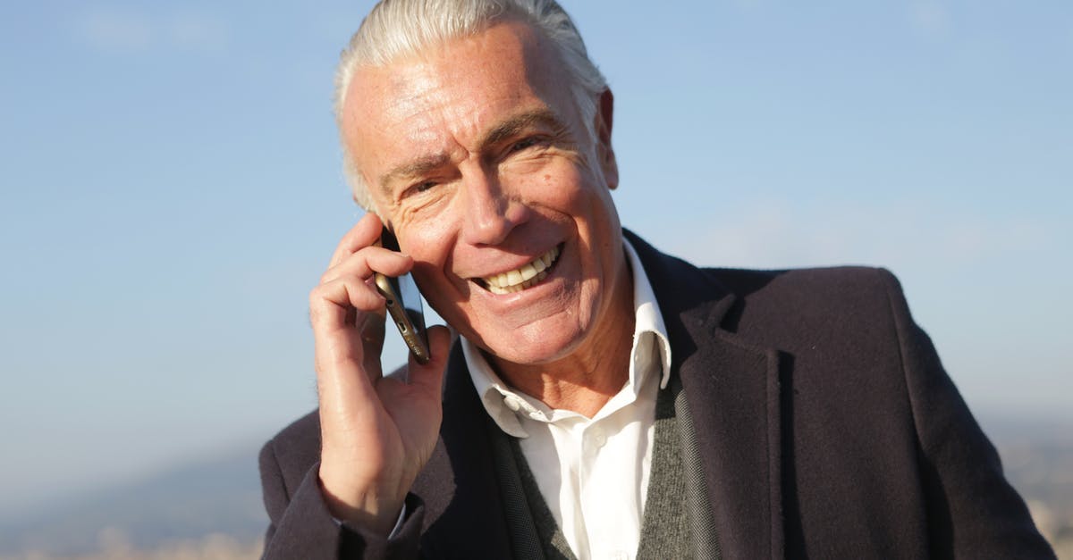 Sous-vide without a pump using convection? - Delighted male entrepreneur wearing classy jacket standing in city and making phone call while smiling and looking at camera Sous-vide without a pump using convection? - Delighted male entrepreneur wearing classy jacket standing in city and making phone call while smiling and looking at camera