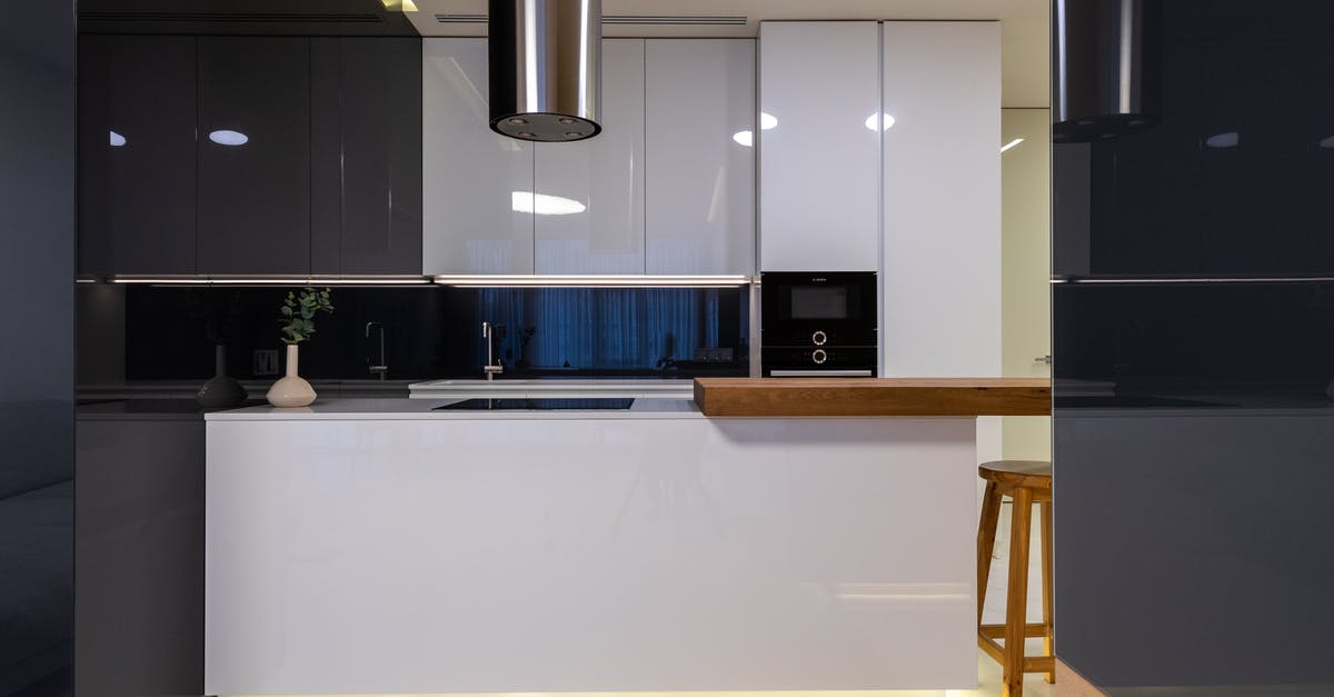 Spots in Stainless Pots after cleaning in self cleaning oven - Interior of stylish kitchen with counter and appliances with cabinets glossy reflecting surface Spots in Stainless Pots after cleaning in self cleaning oven - Interior of stylish kitchen with counter and appliances with cabinets glossy reflecting surface