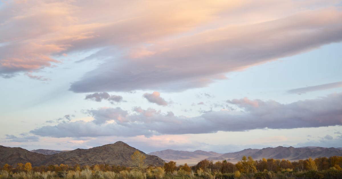 Spring rolls splitting when frozen - Cloudy sky in sunset over field in wind Spring rolls splitting when frozen - Cloudy sky in sunset over field in wind