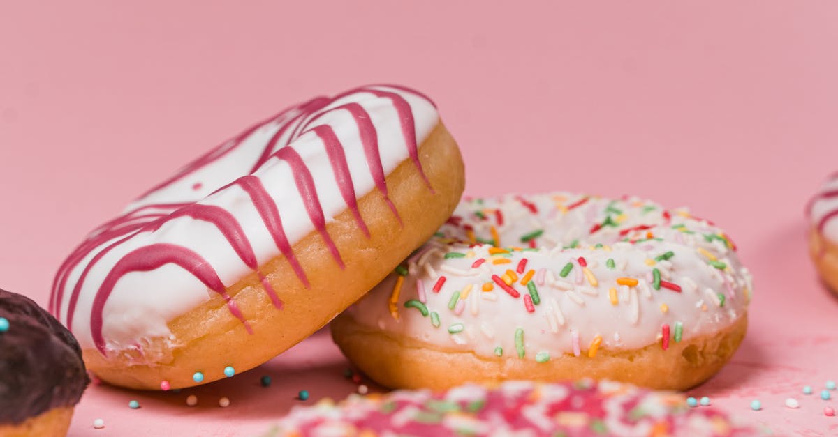 Sprinkles on rolled icing - Close-Up Photo of Colorful Doughnuts Sprinkles on rolled icing - Close-Up Photo of Colorful Doughnuts