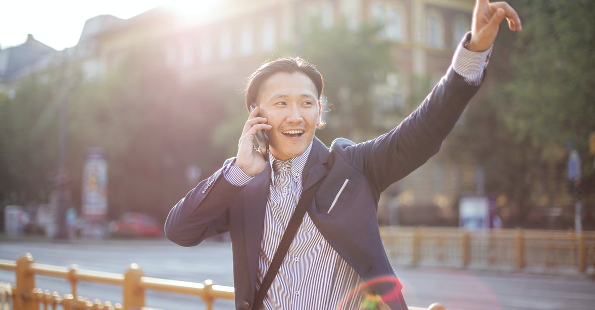 Squash Casserole: Reducing the water content? - Happy adult ethnic man in jacket waving with hand hailing taxi on sunny street while speaking on smartphone Squash Casserole: Reducing the water content? - Happy adult ethnic man in jacket waving with hand hailing taxi on sunny street while speaking on smartphone