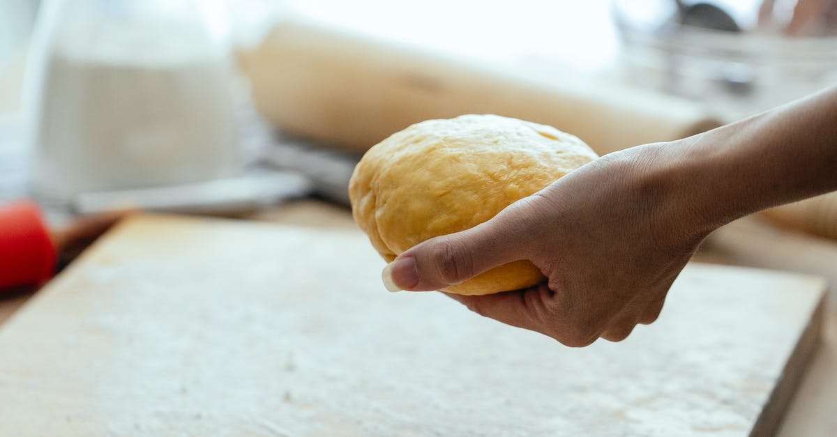 Squashing cookie balls vs slicing them - Female hand with row dough Squashing cookie balls vs slicing them - Female hand with row dough