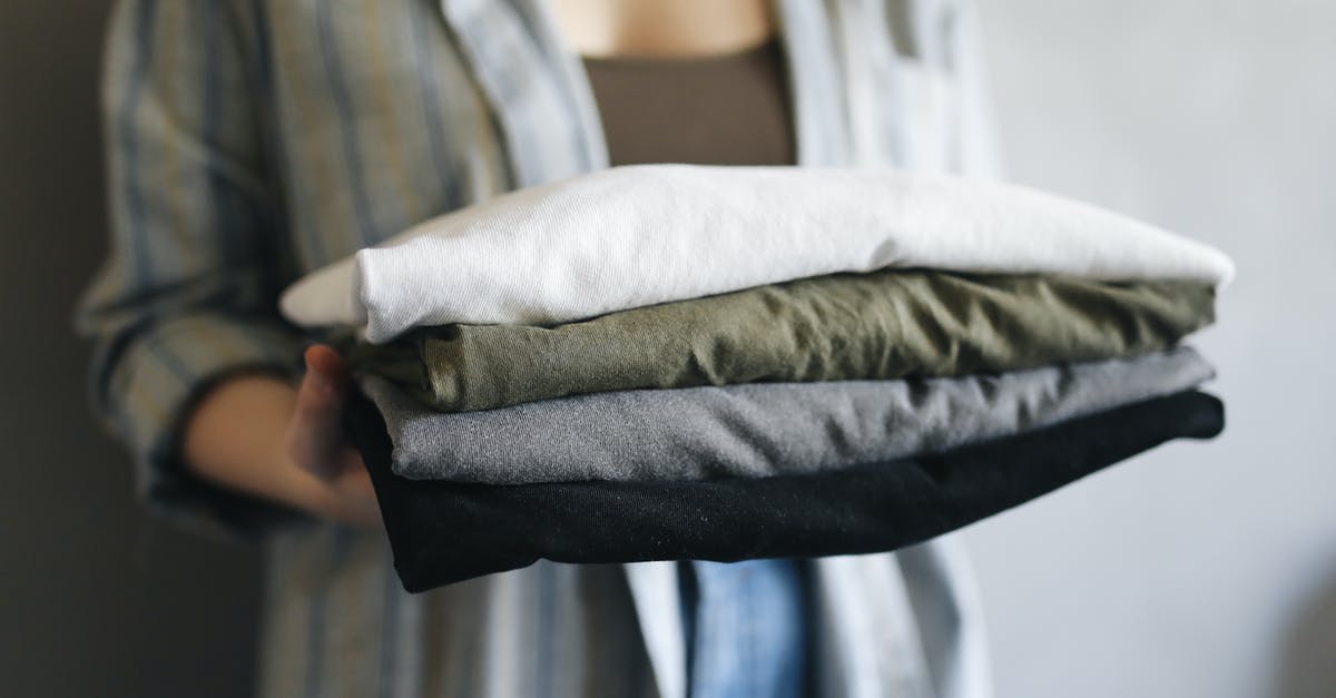 Stack oatverflow [duplicate] - Woman in Blue Denim Jeans Holding White Textile
