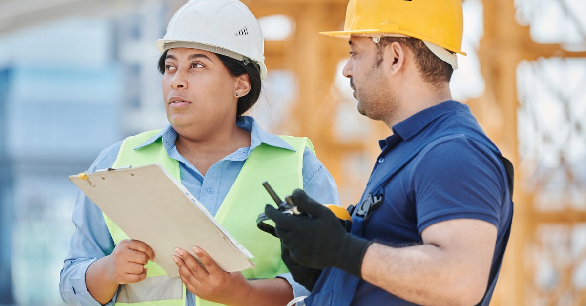 Standing rib roast and safety standards collision - Woman in Blue Long Sleeve Shirt Wearing White Hard Hat Holding White Clipboard Standing rib roast and safety standards collision - Woman in Blue Long Sleeve Shirt Wearing White Hard Hat Holding White Clipboard