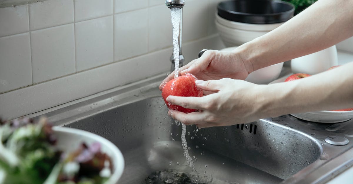 Starter with water, flour, grated apple - Person Washing a Fruit From a Faucet Starter with water, flour, grated apple - Person Washing a Fruit From a Faucet