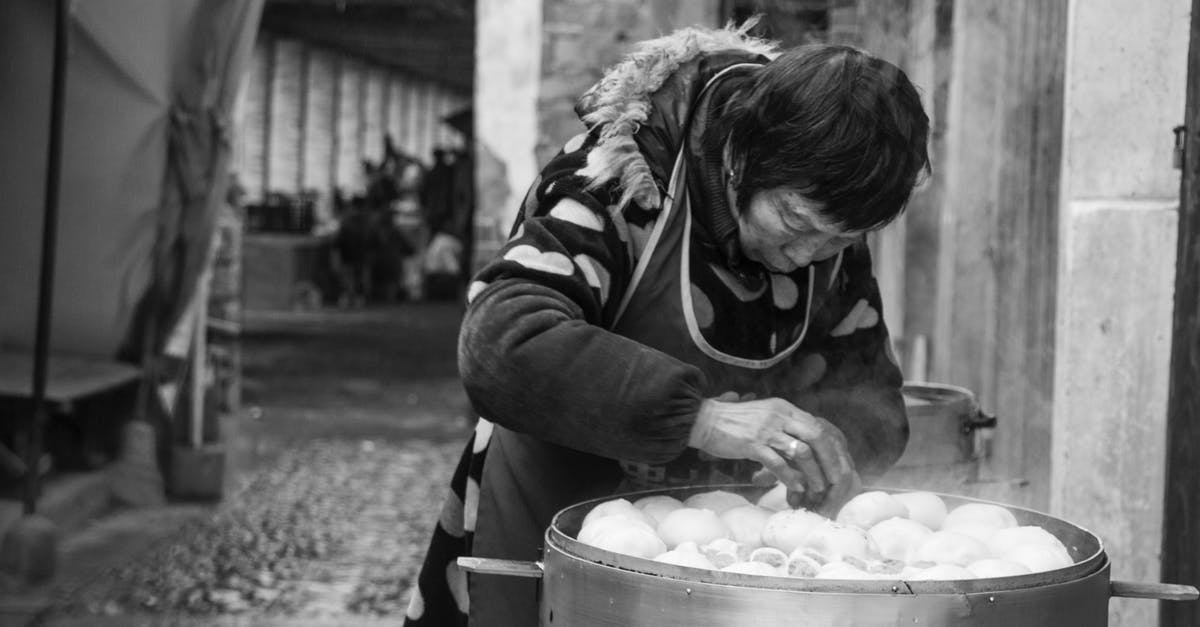 Steaming and steam temperature - Woman Standing and Arranging Buns Steaming and steam temperature - Woman Standing and Arranging Buns