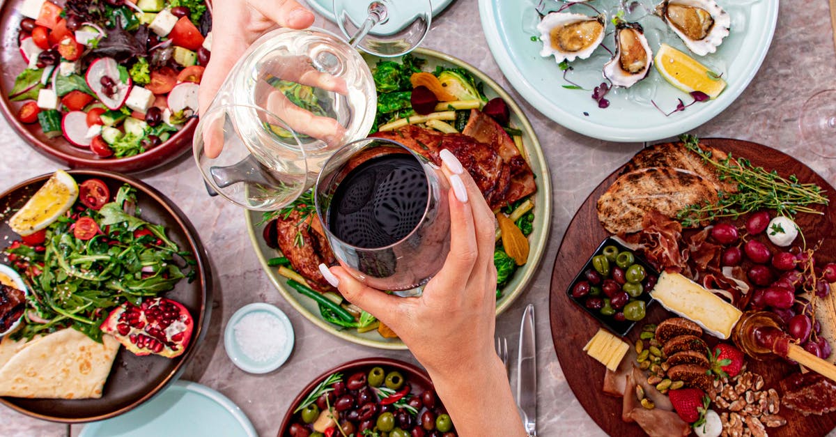 Steaming oysters without shucking meat v. just shucked oyster meat? - A Person holding a Glass of Red Wine Steaming oysters without shucking meat v. just shucked oyster meat? - A Person holding a Glass of Red Wine