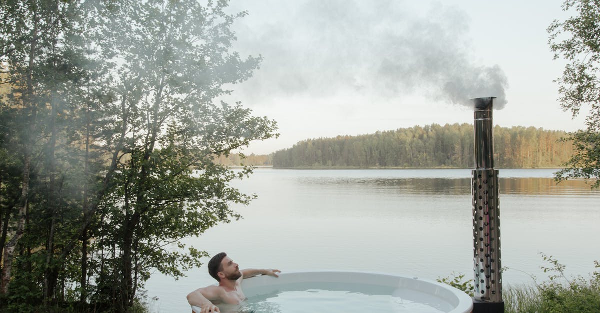 Steaming with oil instead of water - Man and Woman in White and Brown Inflatable Pool Steaming with oil instead of water - Man and Woman in White and Brown Inflatable Pool