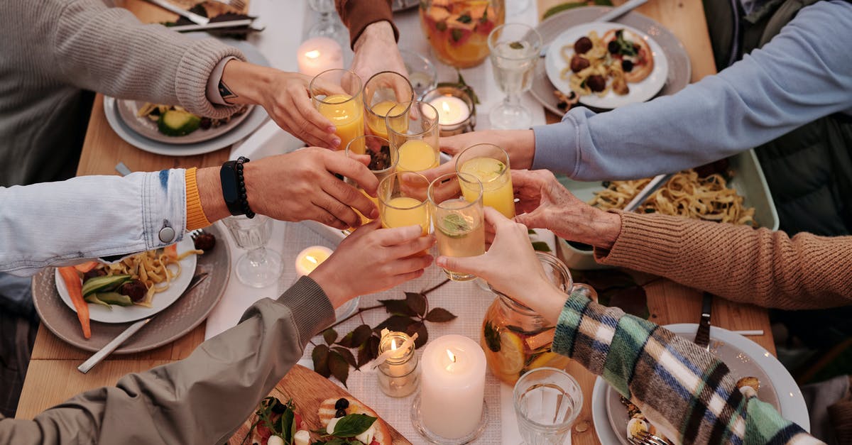 Stop rhubarb compote juice from leaking - From above of crop friends enjoying dinner with candles while cheering with glasses of drinks Stop rhubarb compote juice from leaking - From above of crop friends enjoying dinner with candles while cheering with glasses of drinks