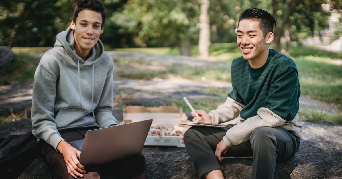 Storing Pizza Stone in Oven - Cheerful multiethnic students working on project together Storing Pizza Stone in Oven - Cheerful multiethnic students working on project together