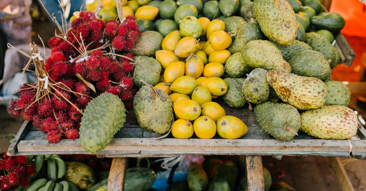 Storing raw cranberry - Assorted tropical fruits on stall at market Storing raw cranberry - Assorted tropical fruits on stall at market